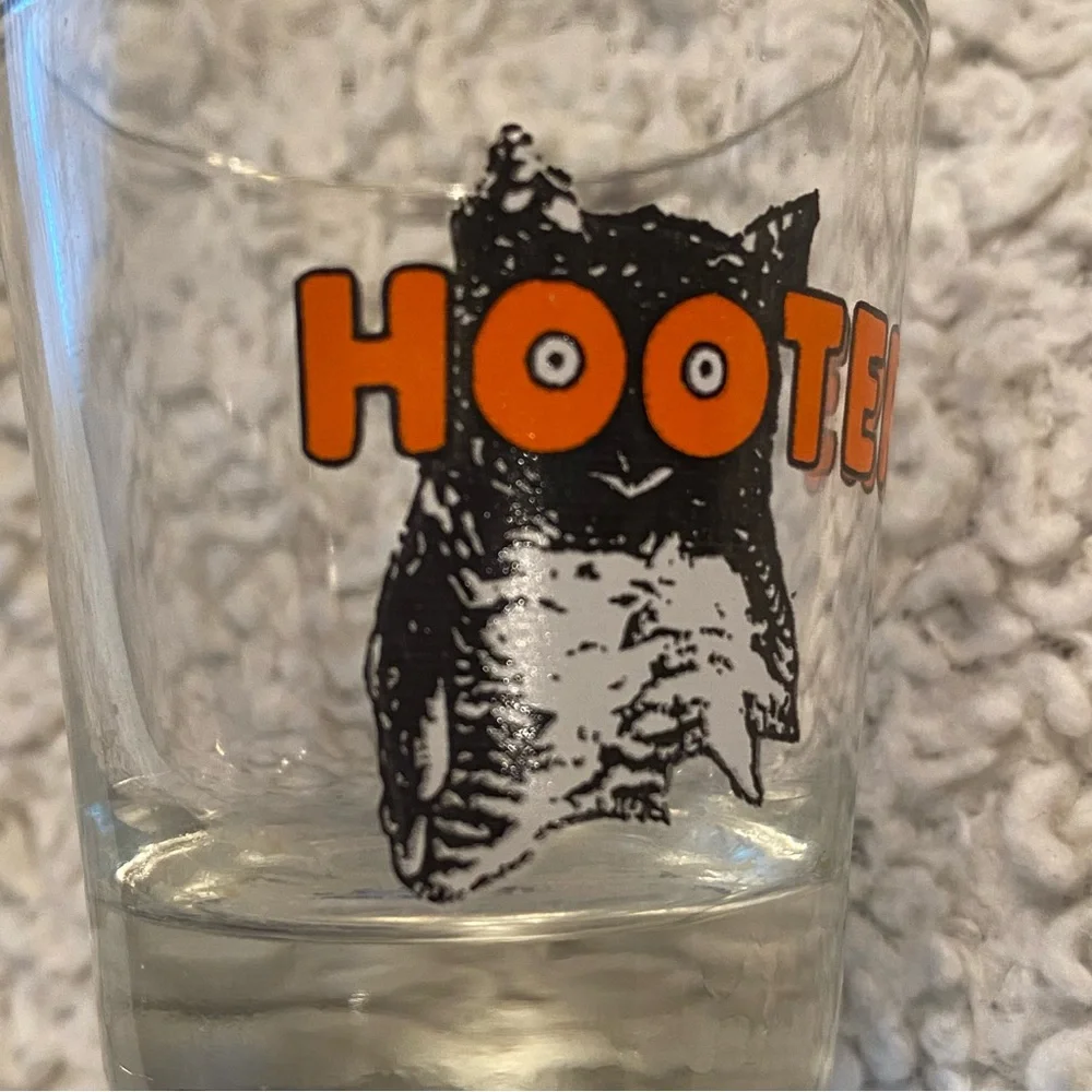 Hooter’s shot glass,  white orange with owl logo, no city specified